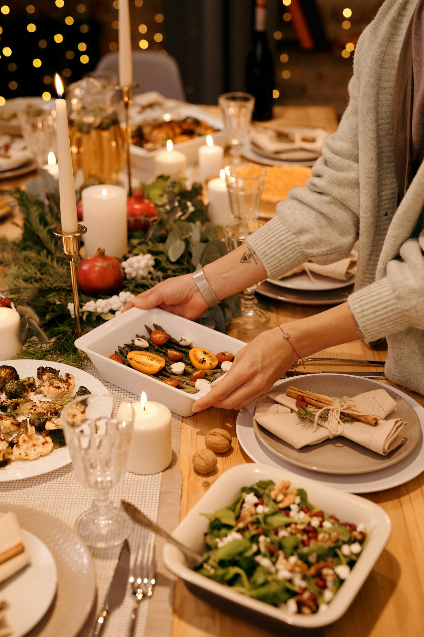 Elegant holiday dinner table with festive decor and delicious dishes being served.